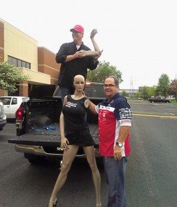 Outside the 93X broadcast office, Tousley Motorsports general manager Peter Jones, right, and salesman Jonny O, assemble  mannequin Shaquiella for her on-air debut. 