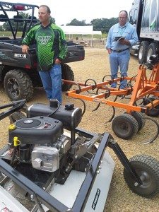 Arctic Cat’s Jeff Lane, left, explains the SPEEDPoint implement line to farm and hunting media at a demo event in late July in Hastings, Minn. 