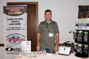 Andrew Hepburn from Ontario-based Outside Distributing tends his booth at the Marshall Distributing show in Frankenmuth, Mich.