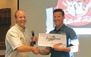 Adam Wood from Starting Line Products presents Marshall’s Greg Simms with the top salesman award.