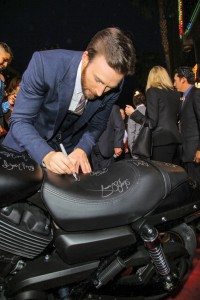 Marvel’s “Captain America: The Winter Soldier” star Chris Evans signs a new Harley-Davidson Street 750 at the premiere in Hollywood, Calif. Following the premiere, Harley-Davidson will donate the bike to Concord Youth Theatre.