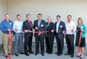 Dave Valentine, Brad Smith, Robert Ostermann, Roy W. Olivier, Mary Pierson, Bill Nurthen, Bob Jones and Theresa DiCello were all smiles for the ribbon-cutting ceremony on a Chamber of Commerce-type day in Duluth, Minn. 