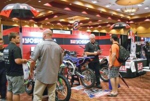 Dave Waugh, director of sales for Yoshimura R&D of America, Inc., center, explains the company’s new franchise kits at the Tucker Rocky Brand Expo in July. 