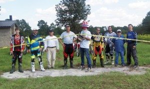 (Left) Riders Nathan Tallman, Justin Robinson, Robbie Robinson, Bob Silles, Fred Pittman, Thomas Gut, Bradley Bryant, Mark Langston and Dale Tallman celebrate the reopening of phase one of the Rattlesnake Bay OHV Trails in Mississippi’s DeSoto National Forest.