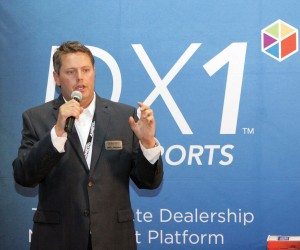 Jeff Littlejohn, president of Dominion Powersports, talks to dealers at AIMExpo in October.