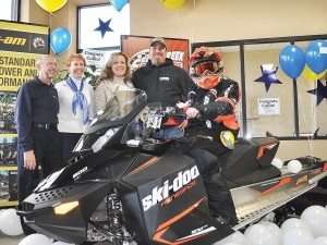 Emil And Sheila Orcholski, Make-A-Wish Wisconsin volunteers; Debbie and Kevin Wilcox, Collin’s parents; and Collin (seated) on his new 2015 Ski-Doo Renegade 600 Sports snowmobile at Cedar Creek Motorsports in Cedarburg, Wis.