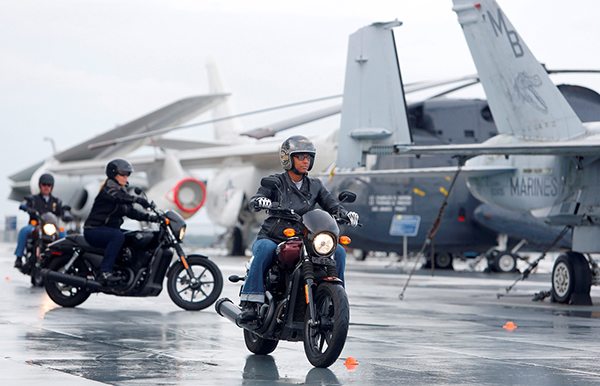 Tamika Whitfield, member of the U.S. Air Force, from Charleston, rides the H-D Street 500 aboard the USS Yorktown Wednesday, May 6, 2015, in Mt. Pleasant, S.C., as Harley-Davidson announced it is offering free Riding Academy to all current and former U.S. Military.  (Mic Smith/AP Images for Harley-Davidson)