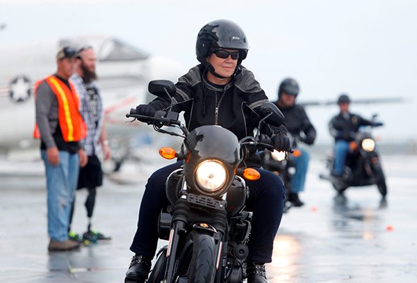 Debi Cole, from James Island, S.C., rides the H-D Street 500 aboard the USS Yorktown Wednesday, May 6, 2015, in Mt. Pleasant, S.C., as Harley-Davidson announced it is offering free Riding Academy to all current and former U.S. Military.  (Mic Smith/AP Images for Harley-Davidson)