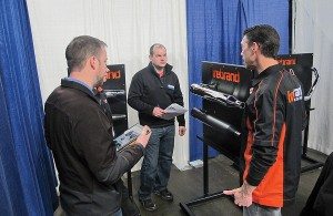 John Peck from Firebrand (right) shows off the company’s newest products to reps at the Western Power Sports National Sales Meeting in Boise, Idaho. 
