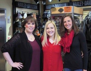 Stephanie Cook (left), manager of MotorClothes at Wild Prairie Harley-Davidson, with heart disease survivor Megan Hicks (center) and Alyssa Siech (right), director of Go Red For Women. Wild Prairie H-D donated 10 percent of the sales of selected items to Go Red For Women for the entire month of February. 