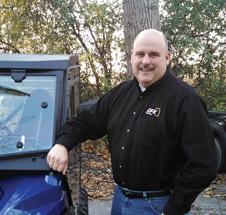 Mike Kelly, vice president and general manager of DFK Cabs, stands alongside DFK’s new cab for the Yamaha Wolverine. 