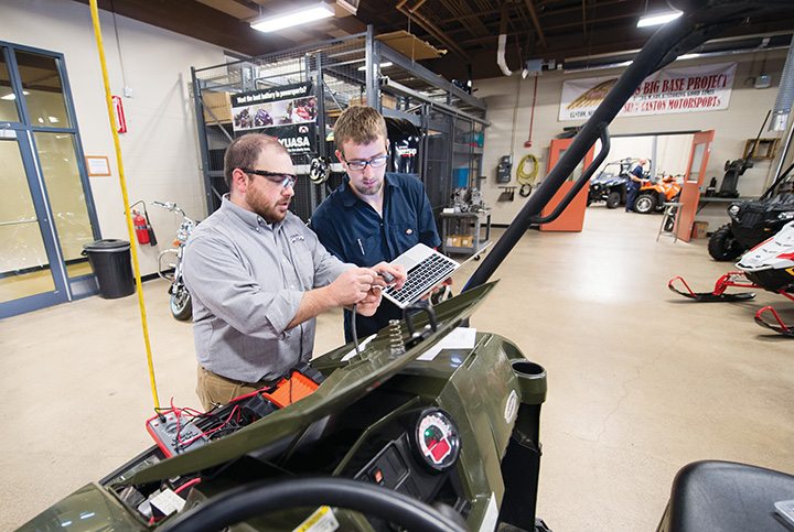 Christopher Mayville (left), talking with a student at SUNY Canton in New York, is a former trainer and technical service representative for Polaris.