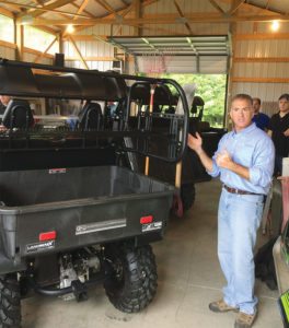 Ty Bello, vice president of sales and marketing for American LandMaster, points out the benefits of the highly functional CrewMate tool rack.