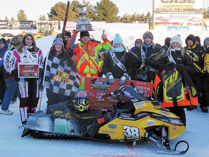 Matt Schulz hoists the coveted Snow Goer Cup after winning his second Eagle River World Championship in Wisconsin.