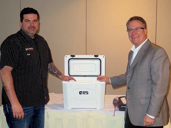 Mark Hendrix, general manager of Ray Price Harley-Davidson, won a cooler in a prize drawing by Federated Insurance’s Scott Raymer.