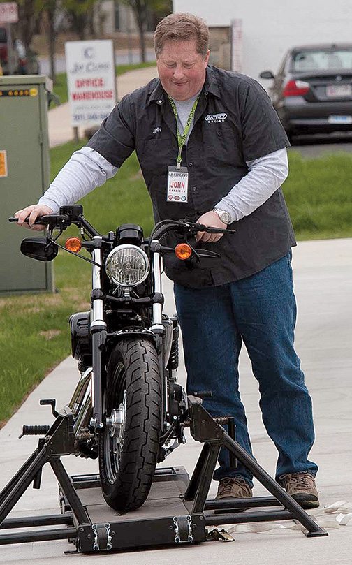 John Hardison, marketing manager for Battley Harley-Davidson, beside the Jumpstart simulator. The event gave 50 people the opportunity to test out how it felt to ride a real motorcycle.