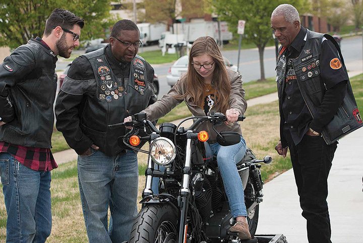 Members of Battley Harley-Davidson’s local HOG chapter show a potential rider how to shift gears on the Jumpstart simulator. 