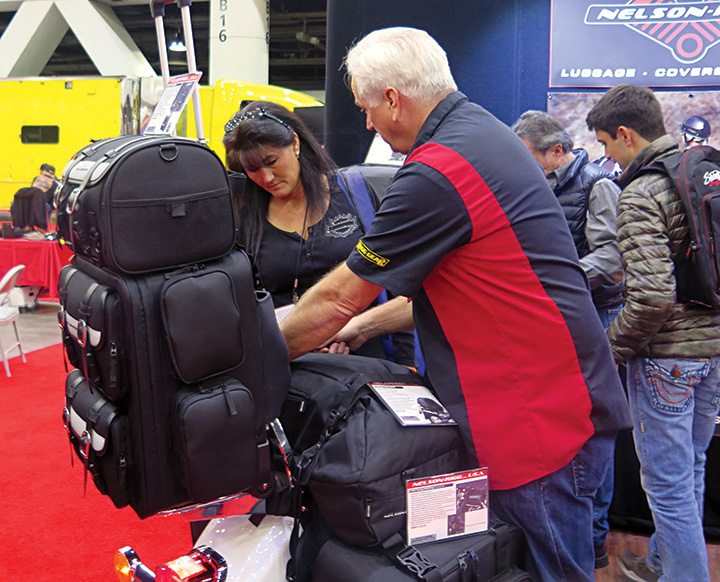 Rick Brooks, brand manager for Nelson-Rigg, shows a V-Twin Expo attendee one of the company’s All Weather Dry Bags. The company’s V-twin products are distributed by Drag Specialties and HardDrive. 