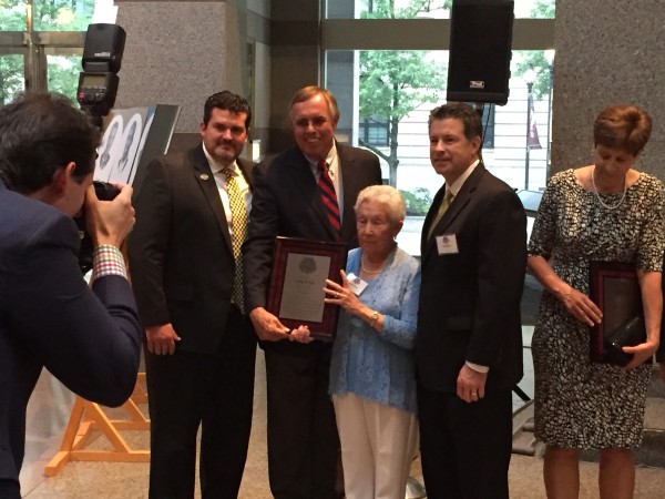 Mark Hendrix, Jean Price and Kris Weiss receive Ray Price's induction plaque at the N.C. Sports Hall of Fame ceremony.