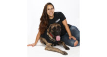 Maggie Stevens, parts manager of ARS Powersports, is pictured with her dog.